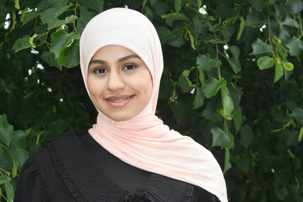 Teen patient smiling with braces at Pioneer Orthodontics